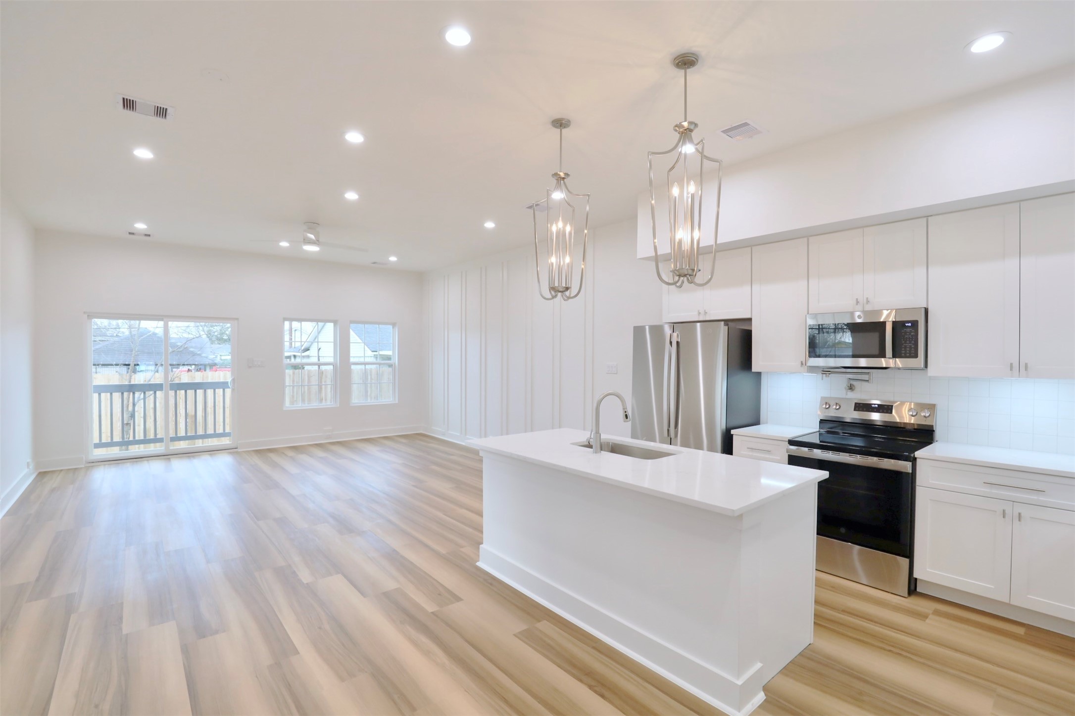 421 East 41st Street Houston, TX 77022 - Photo 15 of 32 a large kitchen with kitchen island a large island in the center and stainless steel appliances