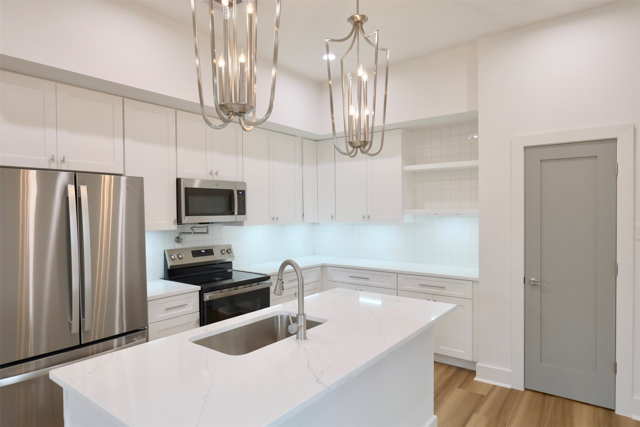 421 East 41st Street Houston, TX 77022 - Photo 10 of 32 a kitchen with stainless steel appliances a sink a refrigerator and microwave