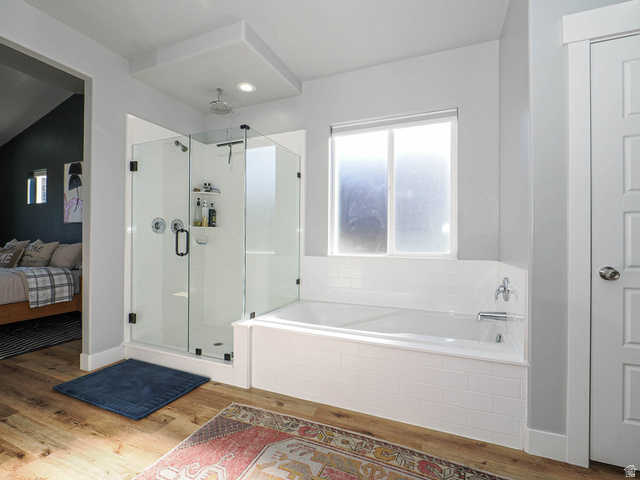 2487 Canyon Wild Road, Unit 413 Draper, UT 84020 - Photo 35 of 75 Ensuite bathroom with a shower stall, light wood-style flooring, and a bath