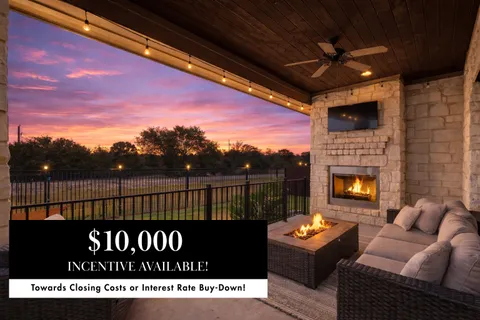 a front view of a house with yard and green space