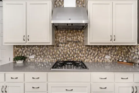 a living room with furniture kitchen view and a window