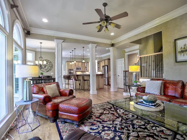 a living room with a fireplace and a wooden floor