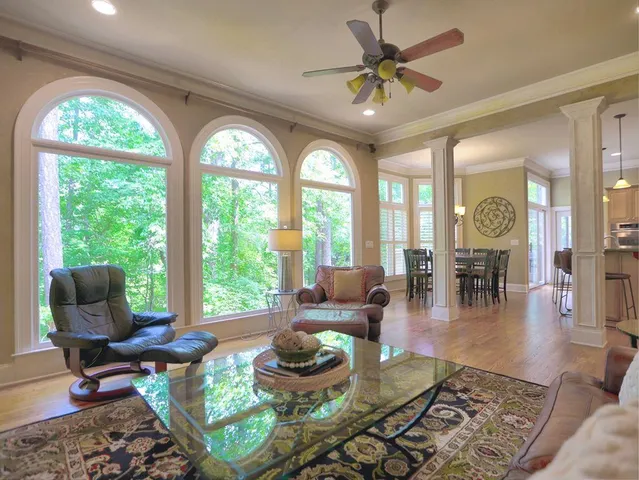 a kitchen with stainless steel appliances granite countertop a refrigerator a stove and a sink with wooden floor