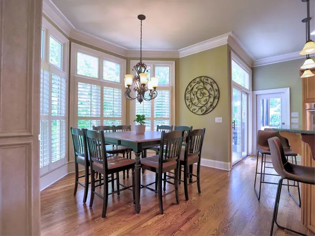 a spacious bedroom with a bed and a chandelier