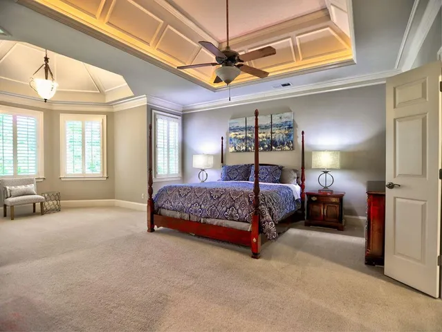 a spacious bathroom with a tub sink and mirror