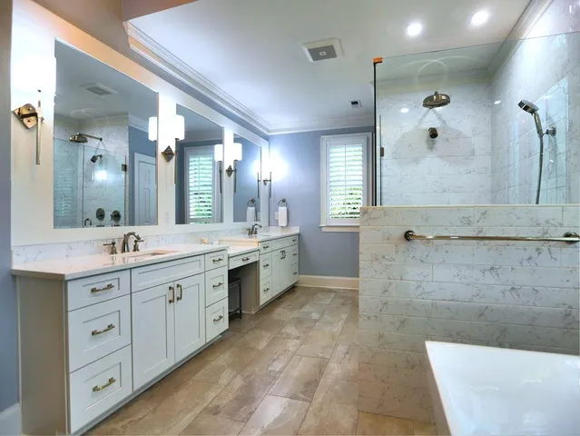a bedroom with a bed a chandelier and dresser