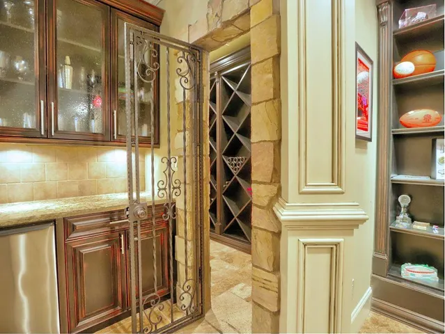 a view of a backyard with plants and large trees