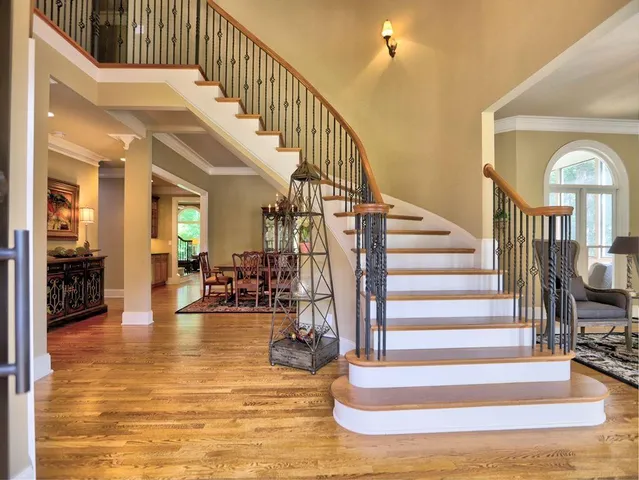 a view of entryway with wooden floor and windows