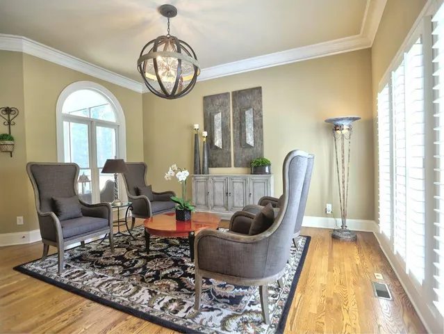 a living room with furniture fireplace and a large window