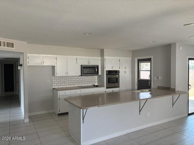 3244 West Yucca Street Phoenix, AZ 85029 - Photo 7 of 21 a kitchen with stainless steel appliances granite countertop a sink and a refrigerator