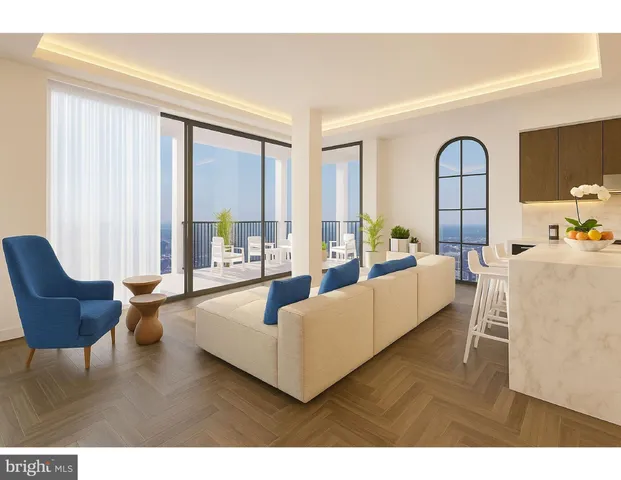 a living room with furniture kitchen view and a window