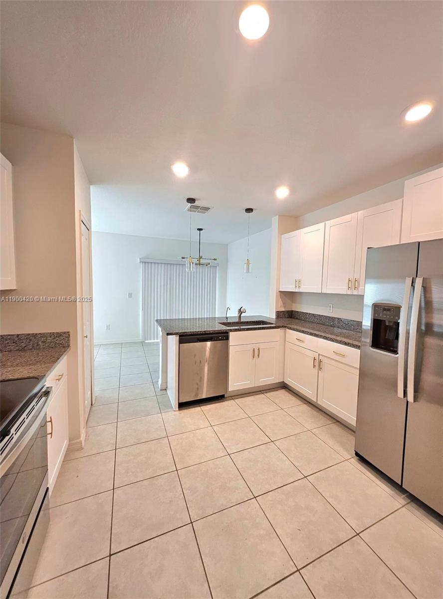 6346 Back Forty Loop Zephyrhills, FL 33541 - Photo 21 of 30 a large kitchen with a stove a sink and a refrigerator