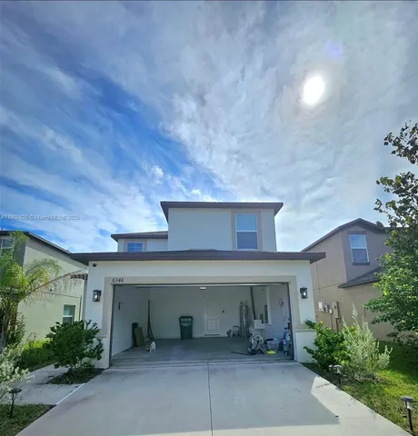 front view of a house with table and chairs