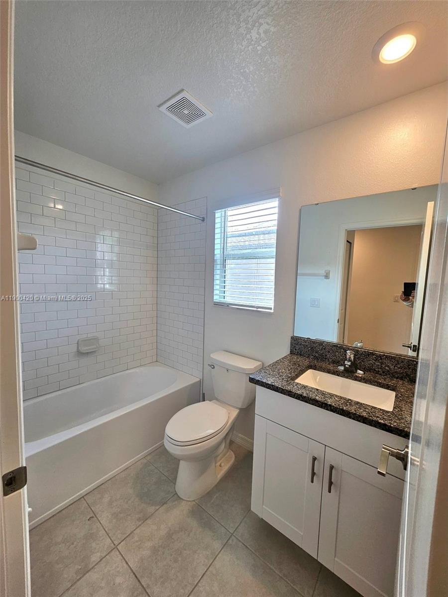 6346 Back Forty Loop Zephyrhills, FL 33541 - Photo 10 of 30 a bathroom with a granite countertop sink toilet mirror and bathtub