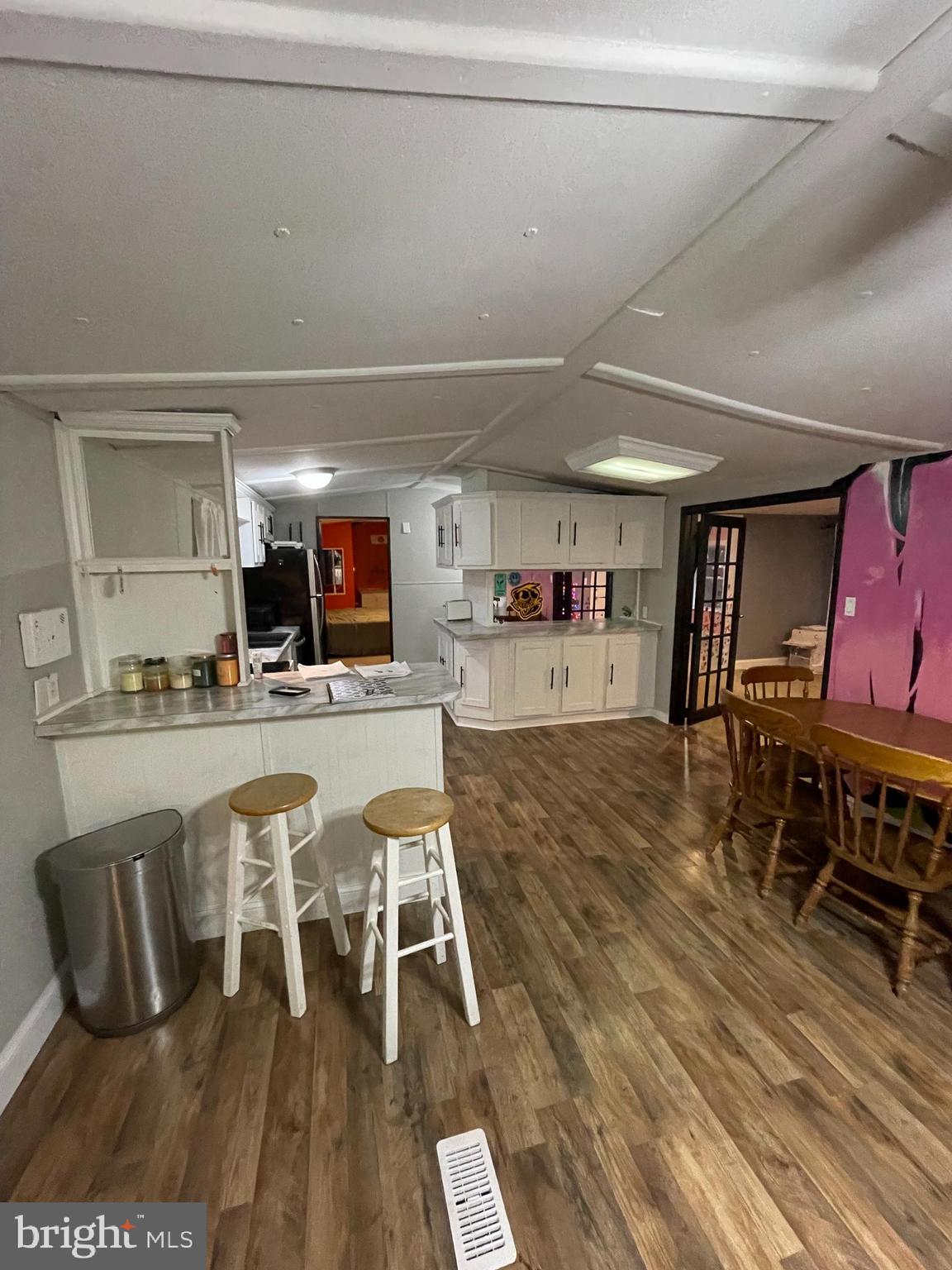 203 Shorewind Road, Unit 203 Bear, DE 19701 - Photo 12 of 20 a living room with stainless steel appliances furniture a rug and a kitchen view