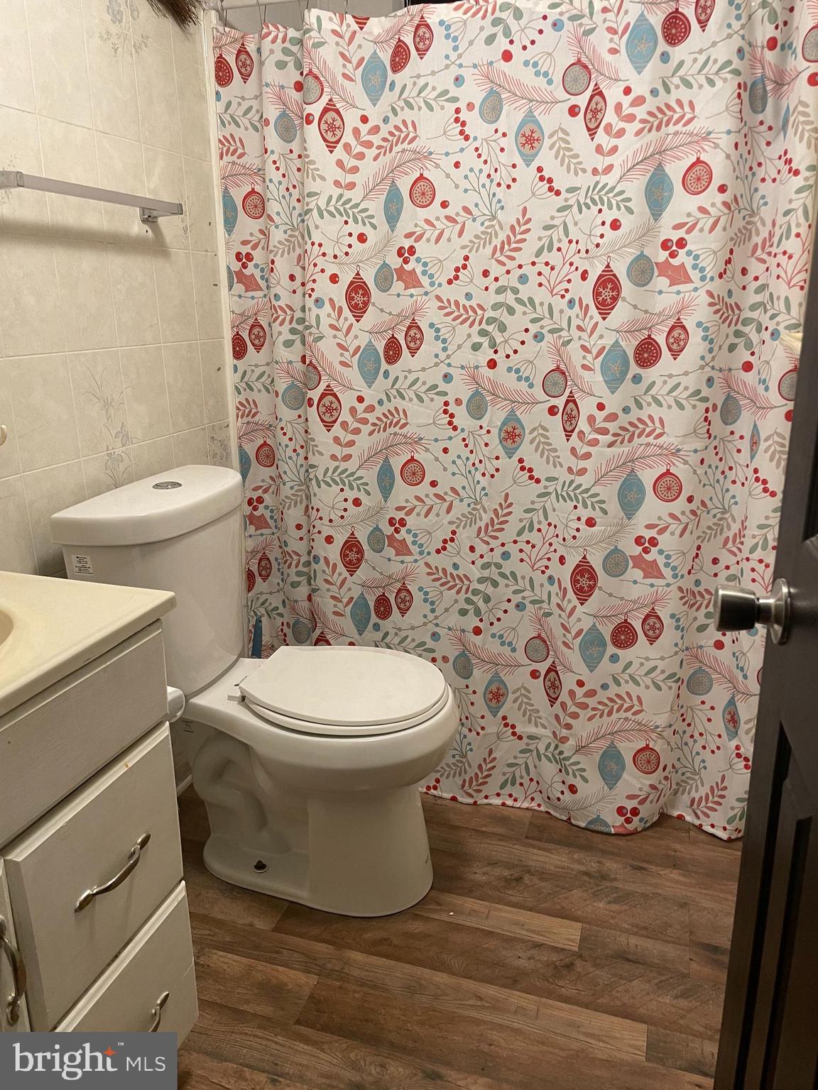 203 Shorewind Road, Unit 203 Bear, DE 19701 - Photo 16 of 20 a white toilet sitting next to a shower curtain
