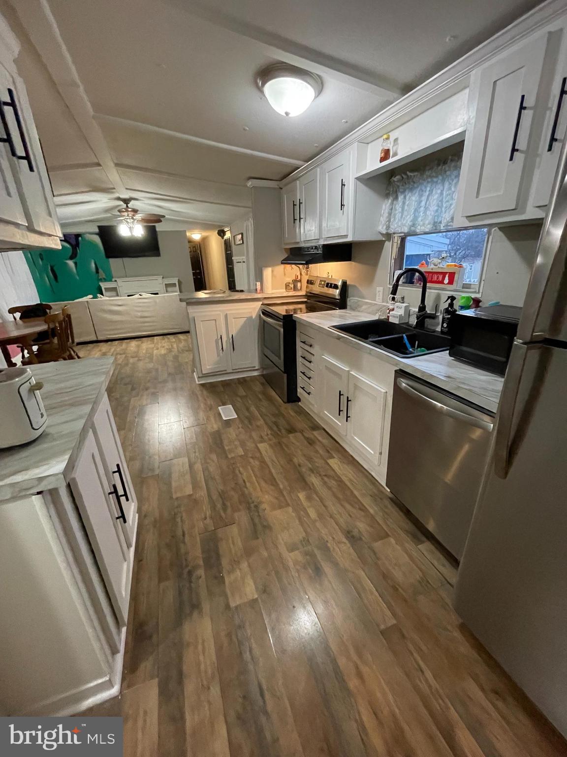 203 Shorewind Road, Unit 203 Bear, DE 19701 - Photo 19 of 20 a kitchen with granite countertop a sink a stove and cabinets