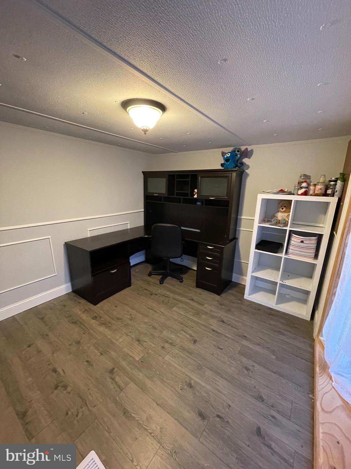 203 Shorewind Road, Unit 203 Bear, DE 19701 - Photo 20 of 20 a room with furniture and a flat screen tv
