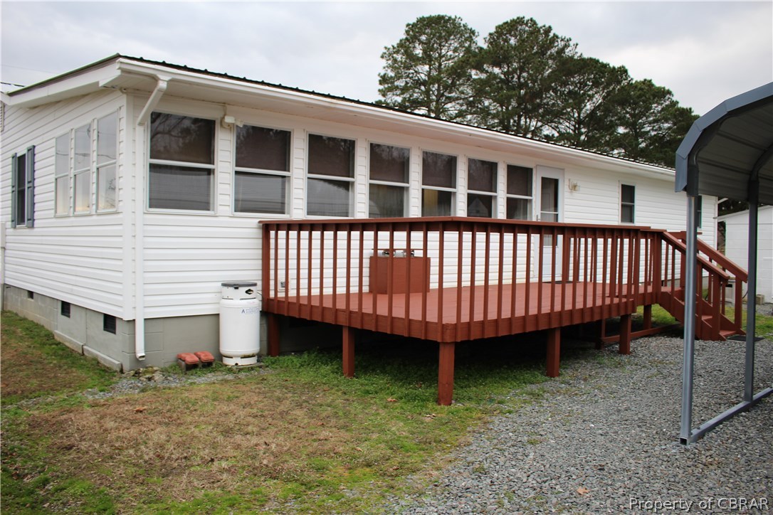 1174 North River Road Bohannon, VA 23021 - Photo 29 of 35 a view of a house with a yard and deck