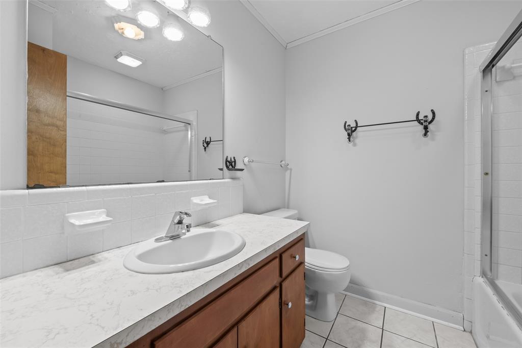 3092 North Trinity Street Decatur, TX 76234 - Photo 13 of 29 a bathroom with a sink toilet and a mirror