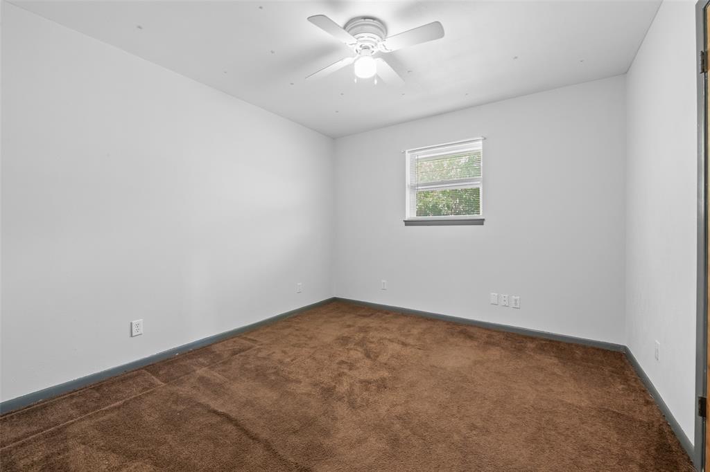 3092 North Trinity Street Decatur, TX 76234 - Photo 14 of 29 an empty room with a window and a fan