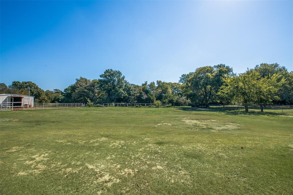 3092 North Trinity Street Decatur, TX 76234 - Photo 20 of 29 a view of a green field with wooden fence