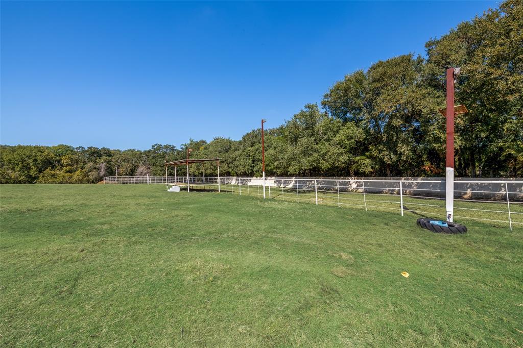 3092 North Trinity Street Decatur, TX 76234 - Photo 27 of 29 a view of a green field with wooden fence