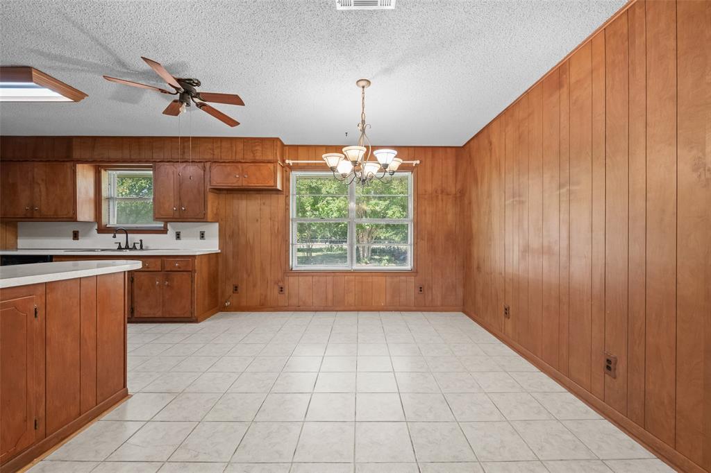 3092 North Trinity Street Decatur, TX 76234 - Photo 7 of 29 a kitchen with stainless steel appliances a sink cabinets and a window
