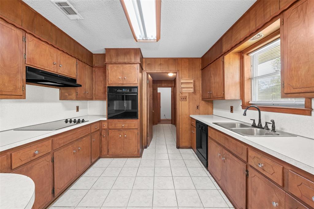 3092 North Trinity Street Decatur, TX 76234 - Photo 8 of 29 a large kitchen with stainless steel appliances granite countertop a sink and cabinets