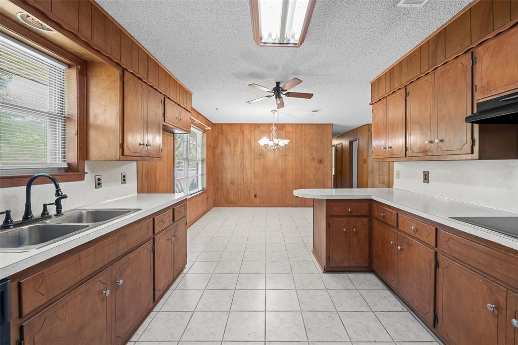 3092 North Trinity Street Decatur, TX 76234 - Photo 9 of 29 a large kitchen with stainless steel appliances granite countertop a sink and cabinets