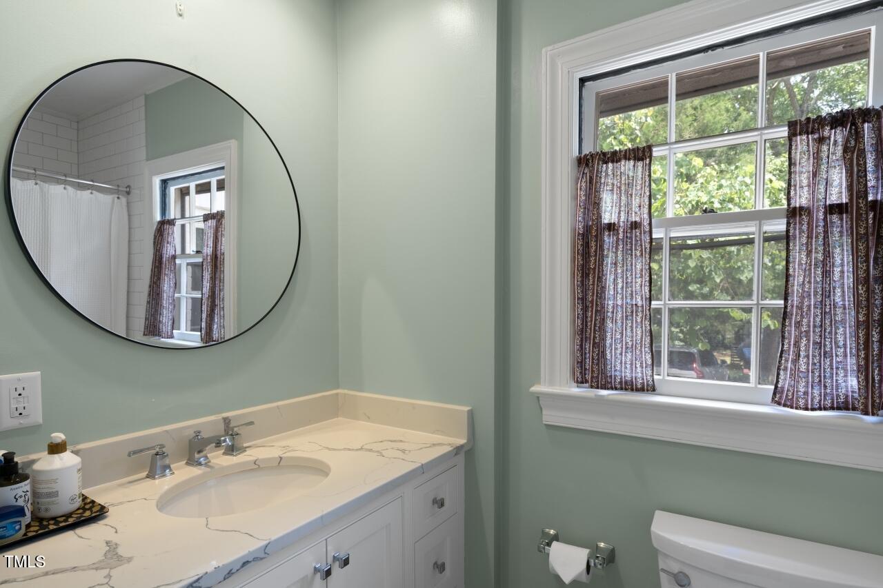 2726 Anderson Drive Raleigh, NC 27608 - Photo 16 of 45 a bathroom with a sink mirror and a window
