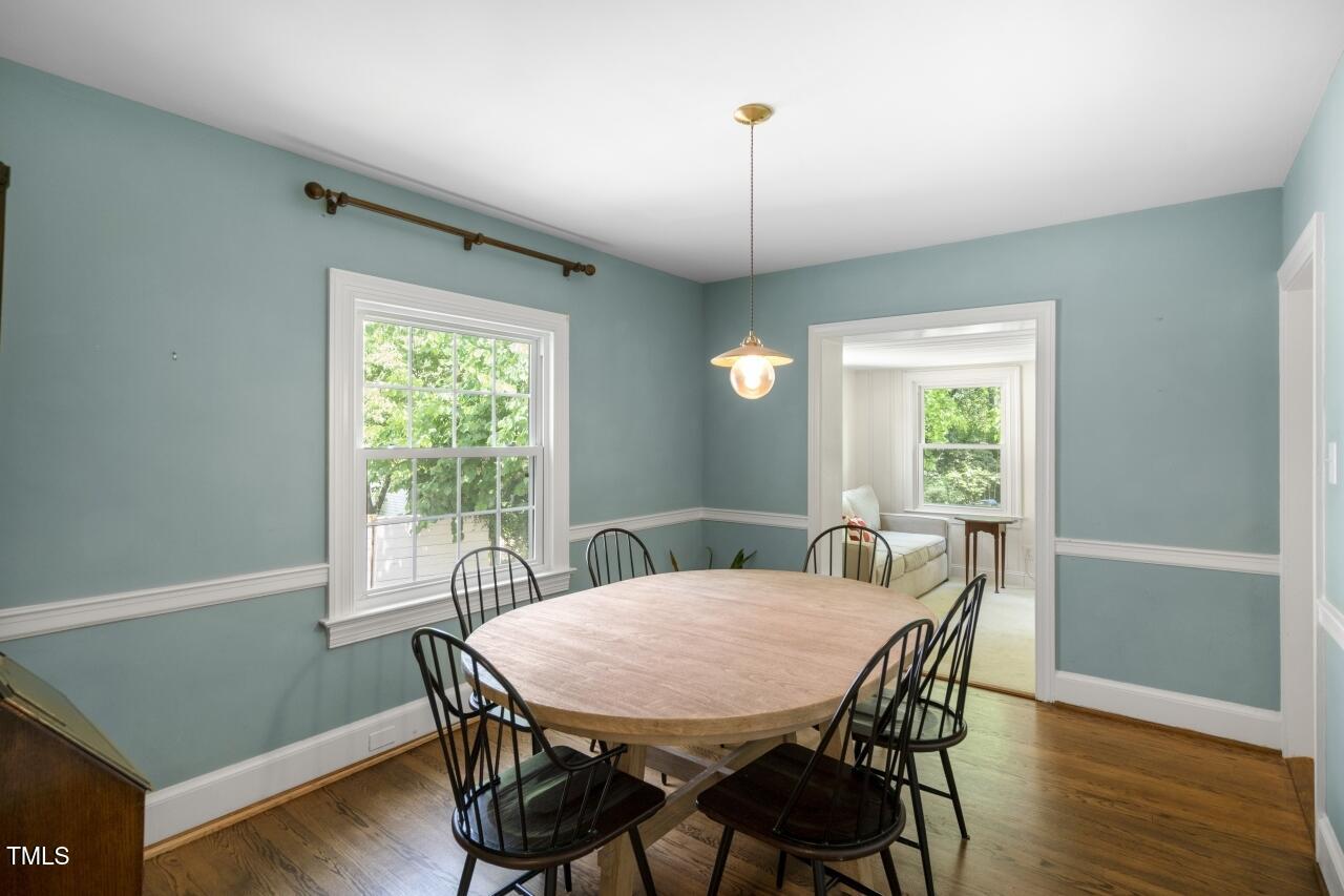 2726 Anderson Drive Raleigh, NC 27608 - Photo 17 of 45 a view of a dining room with furniture window and wooden floor
