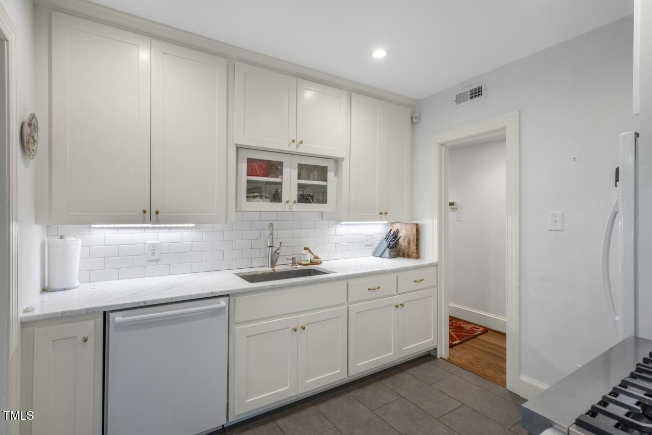 2726 Anderson Drive Raleigh, NC 27608 - Photo 19 of 45 a bathroom with a double vanity sink and mirror