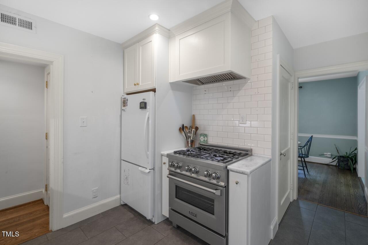 2726 Anderson Drive Raleigh, NC 27608 - Photo 20 of 45 a kitchen with stainless steel appliances a stove and a refrigerator