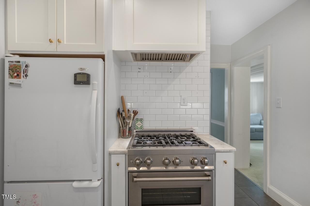 2726 Anderson Drive Raleigh, NC 27608 - Photo 22 of 45 a stove top oven sitting inside of a kitchen