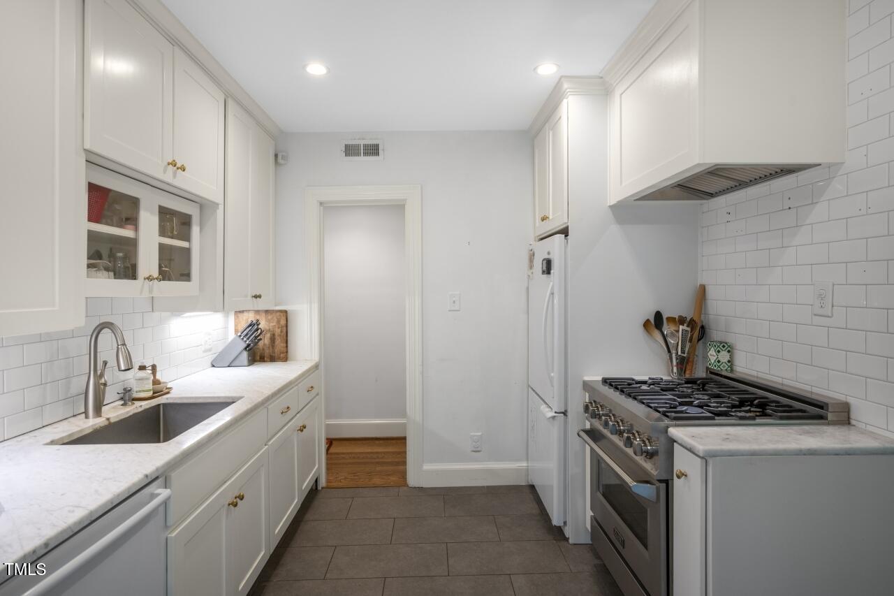 2726 Anderson Drive Raleigh, NC 27608 - Photo 23 of 45 a kitchen with a sink stove and refrigerator