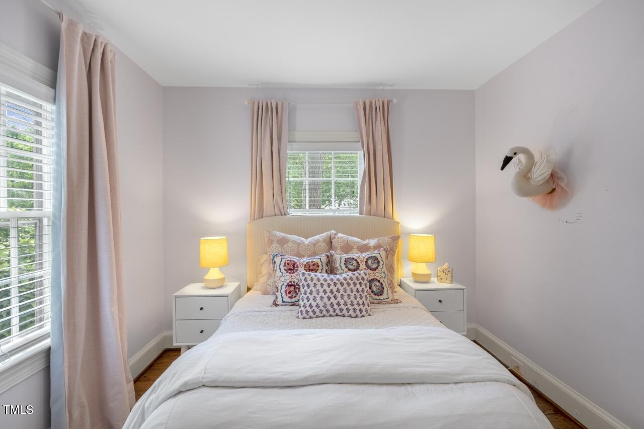 2726 Anderson Drive Raleigh, NC 27608 - Photo 25 of 45 a bedroom with a bed and wooden floor