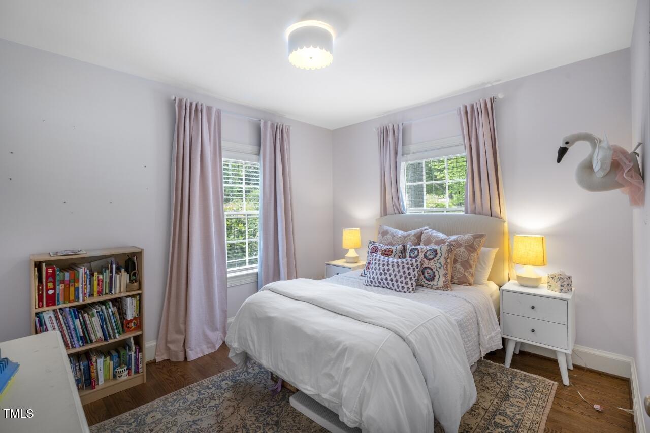 2726 Anderson Drive Raleigh, NC 27608 - Photo 26 of 45 a bedroom with a bed and a book shelf