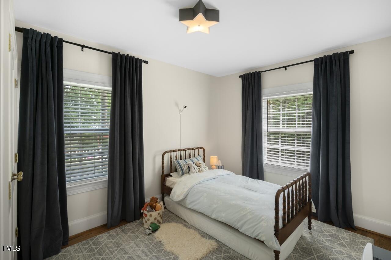 2726 Anderson Drive Raleigh, NC 27608 - Photo 27 of 45 a bedroom with a bed and a window