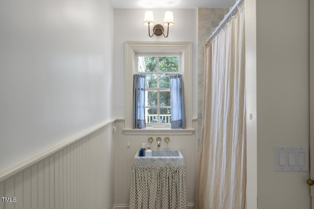 2726 Anderson Drive Raleigh, NC 27608 - Photo 29 of 45 a view of a door and chair in a room
