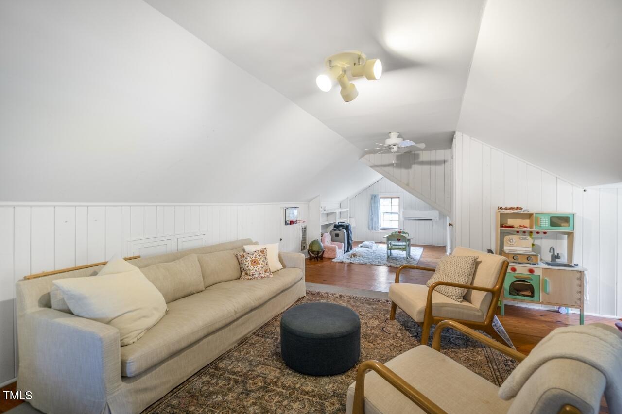2726 Anderson Drive Raleigh, NC 27608 - Photo 31 of 45 a living room with furniture a chandelier and a couch