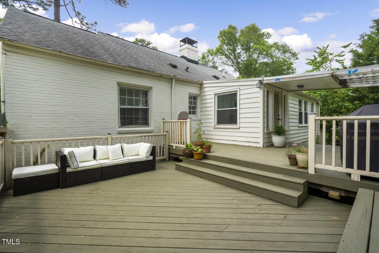 2726 Anderson Drive Raleigh, NC 27608 - Photo 38 of 45 a view of a deck with couches floor to ceiling window with wooden floor