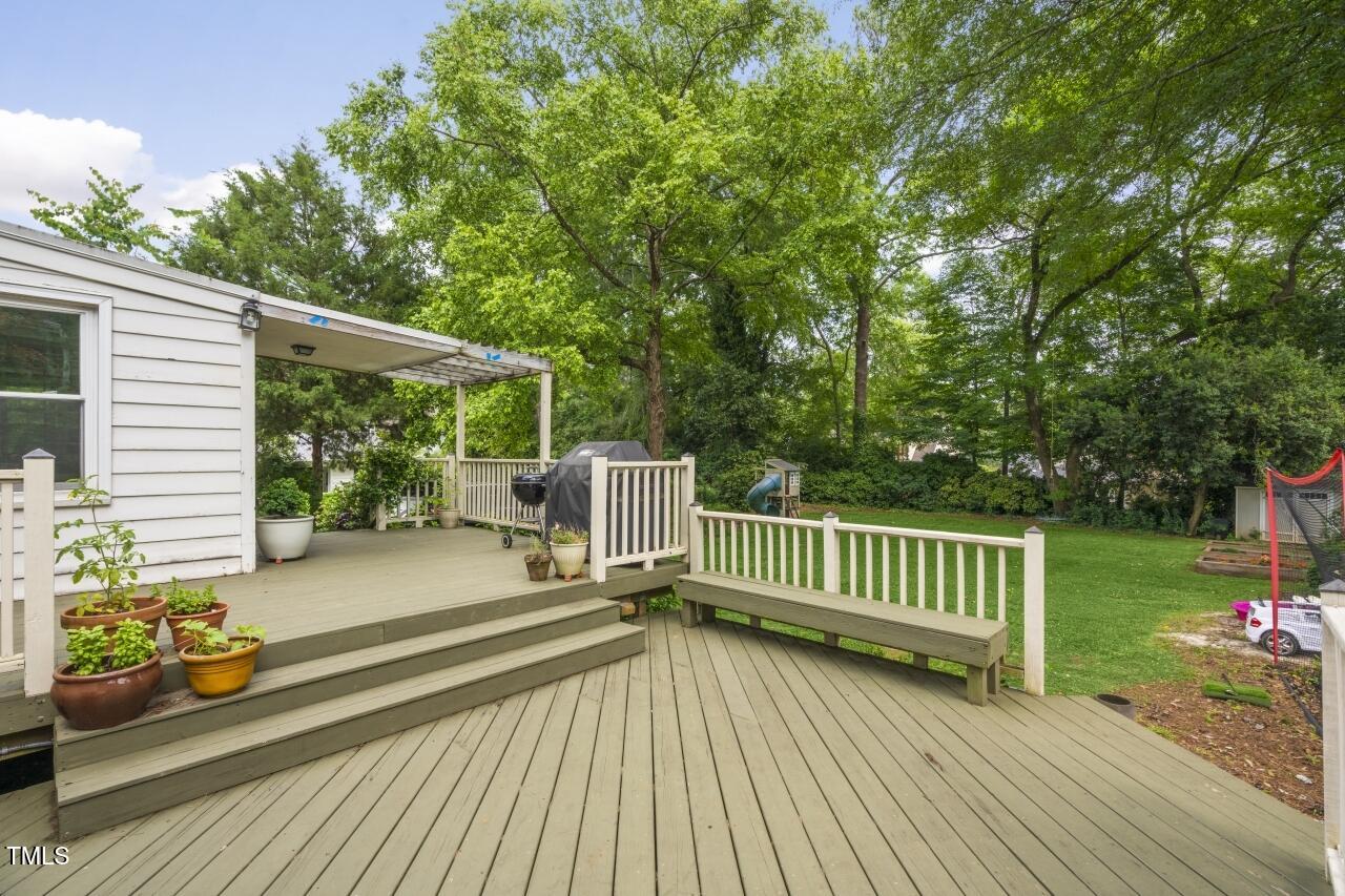 2726 Anderson Drive Raleigh, NC 27608 - Photo 39 of 45 a view of a deck with a table and chairs and wooden floor