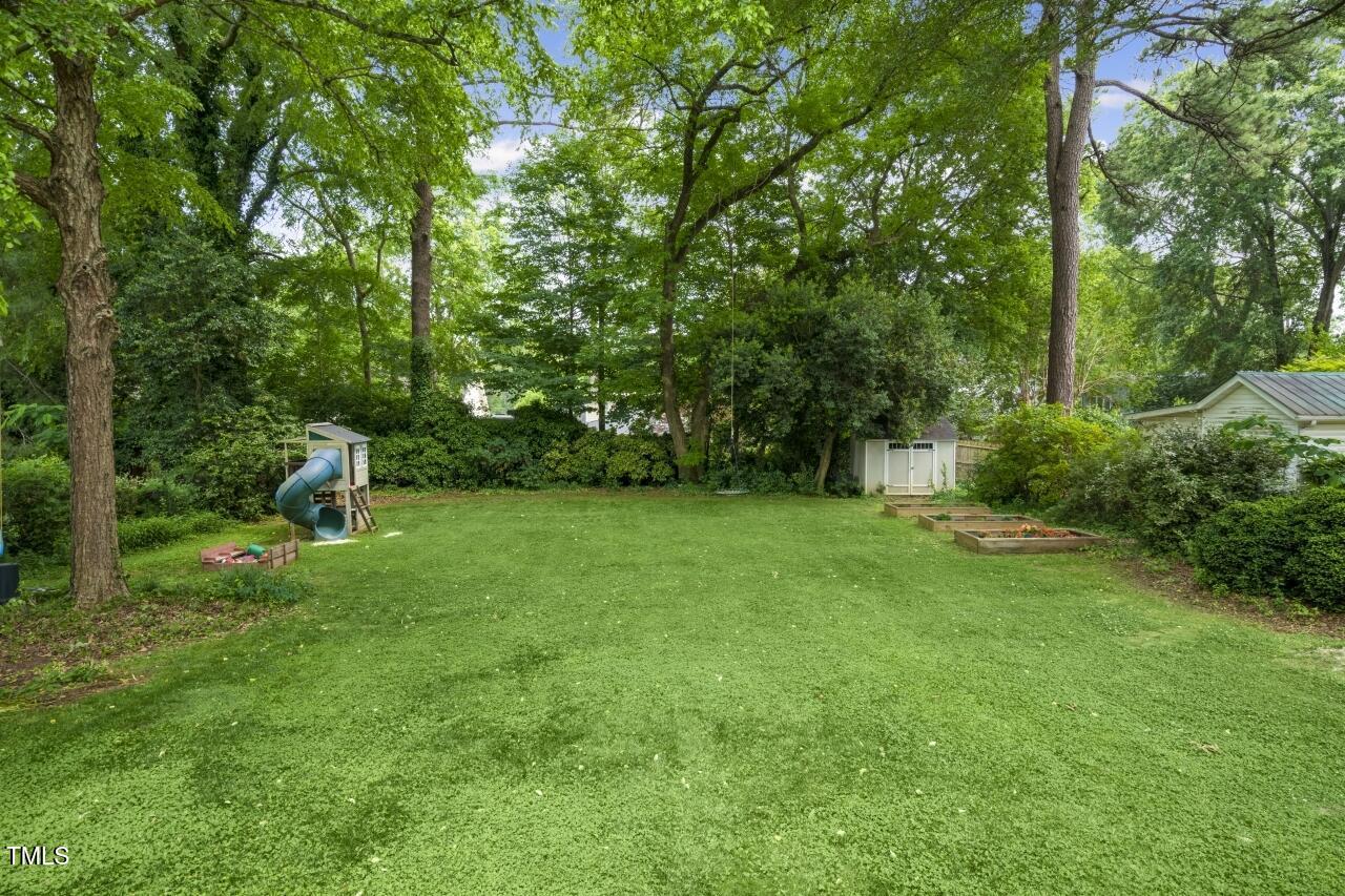2726 Anderson Drive Raleigh, NC 27608 - Photo 41 of 45 a green field with lots of trees in it