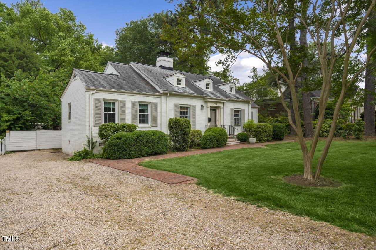 2726 Anderson Drive Raleigh, NC 27608 - Photo 5 of 45 a front view of a house with a garden and yard