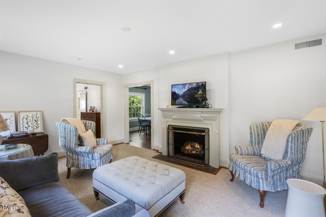2726 Anderson Drive Raleigh, NC 27608 - Photo 7 of 45 a living room with furniture and a fireplace