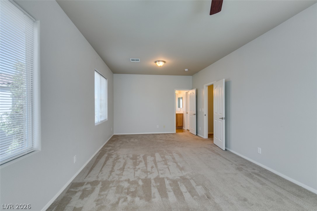 8937 Caledon Ridge Court Las Vegas, NV 89149 - Photo 35 of 43 A quiet bedroom with ample light, ready for personalized touches.