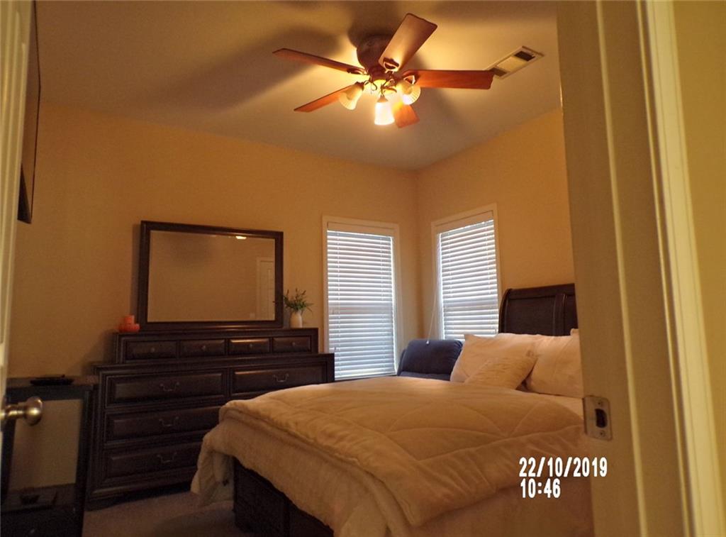 1035 Upchurch Road McDonough, GA 30252 - Photo 11 of 48 a bedroom with a bed and a flat tv screen on dresser