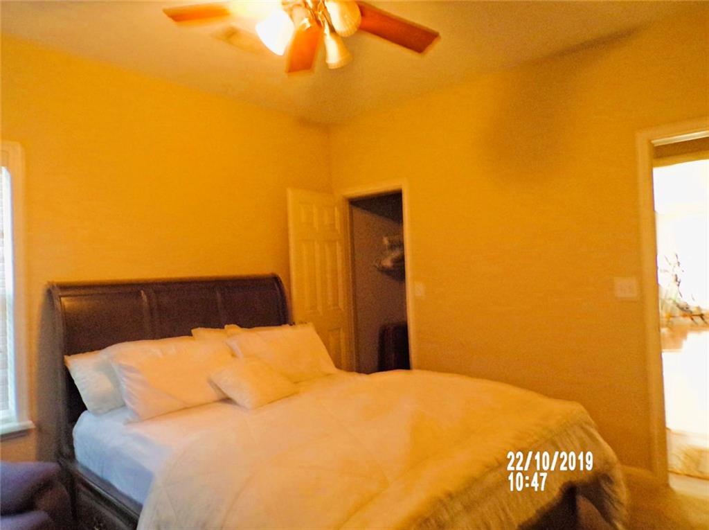 1035 Upchurch Road McDonough, GA 30252 - Photo 13 of 48 a bedroom with a bed and a night stand
