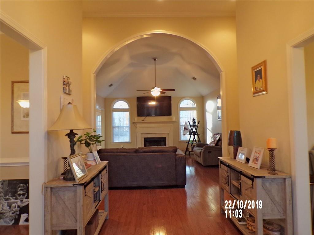 1035 Upchurch Road McDonough, GA 30252 - Photo 25 of 48 a living room with furniture a fireplace and wooden floor